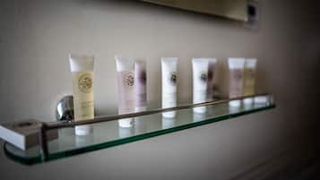 A bathroom shelf with various toiletries.