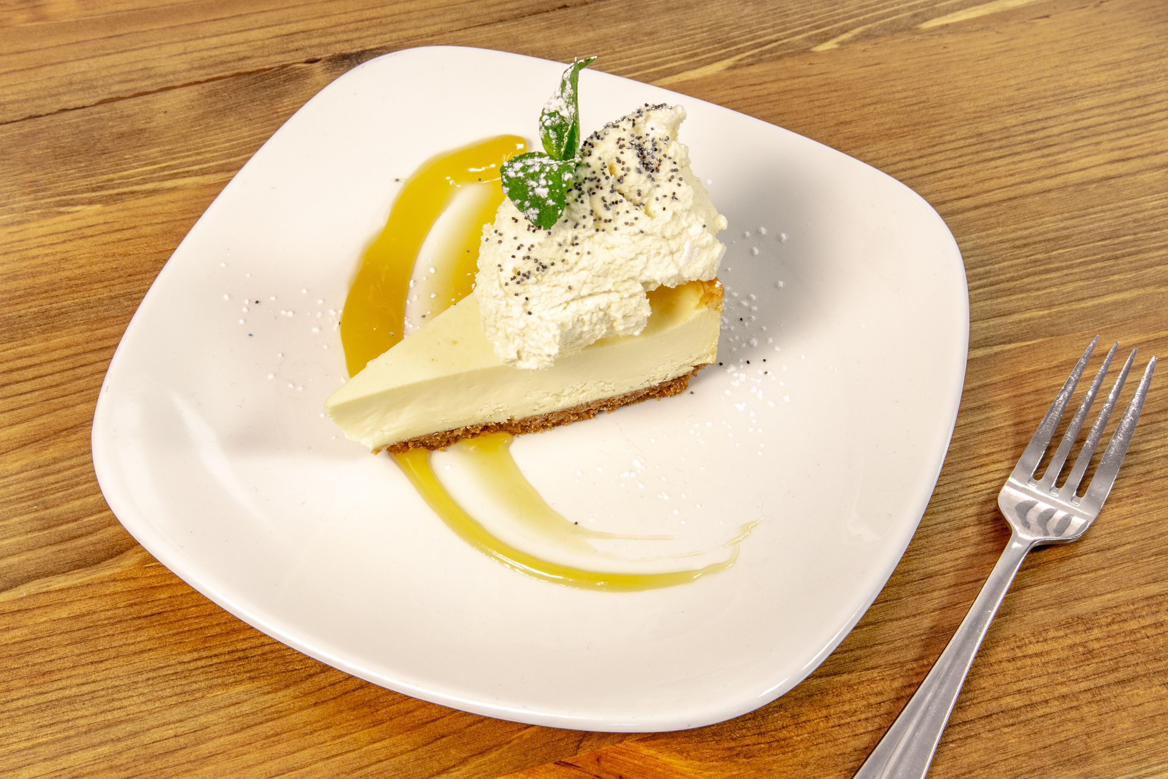 A dessert on a white plate with a fork beside it.