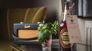 A bottle of Bishop Finger beer with a tag on a table.