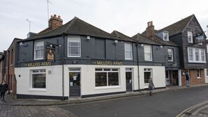 A two-story building with the sign "The Millers Arms" on the ground floor. - The Millers Arms (Canterbury)