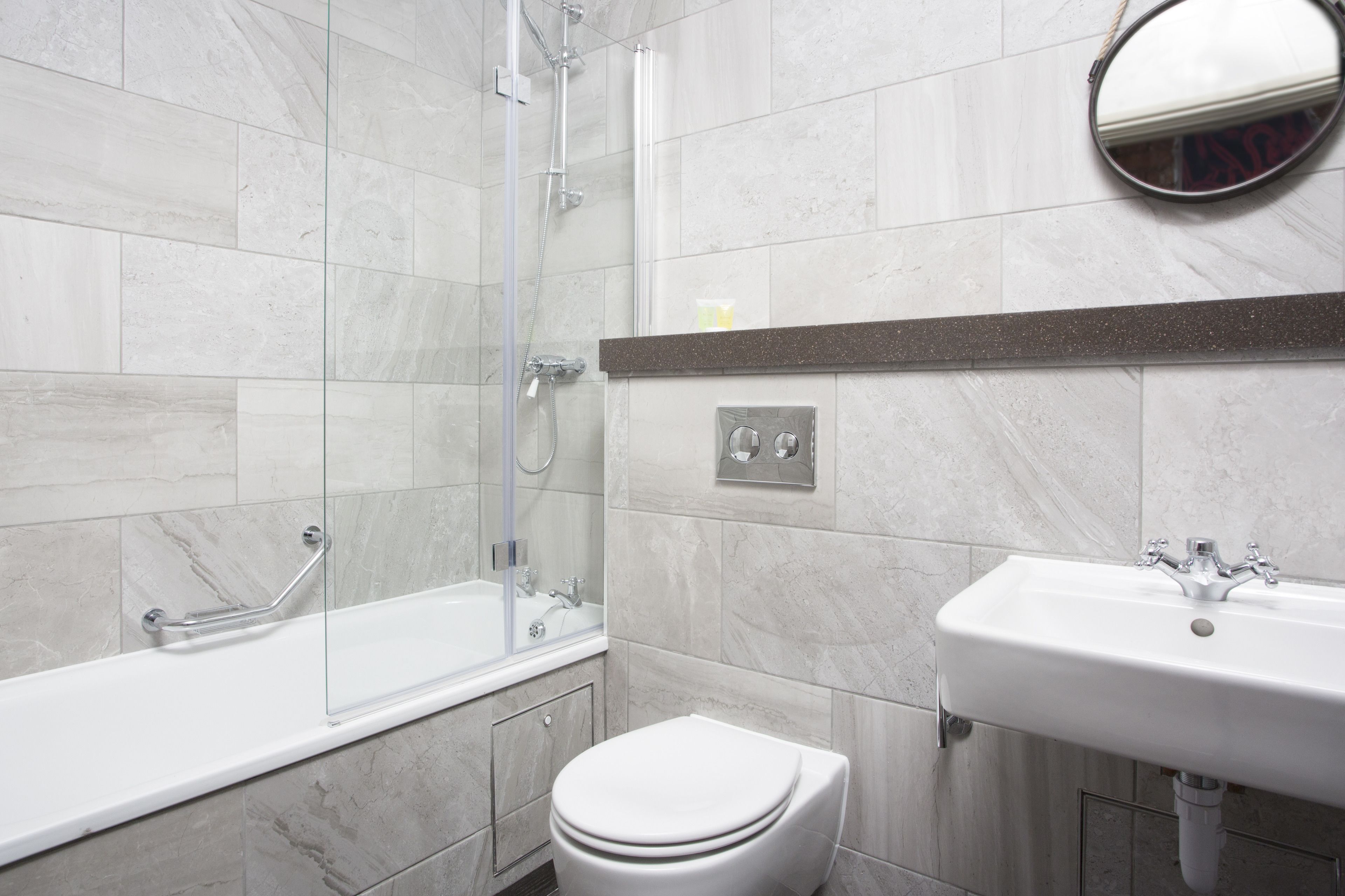 A bathroom with a bathtub, toilet, and sink.