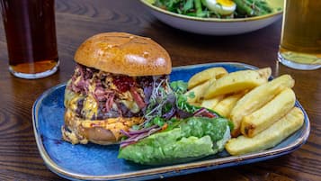 A plate with a sandwich, fries, and a salad.