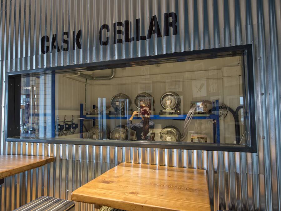 A storefront with a metal exterior and a window displaying various items.