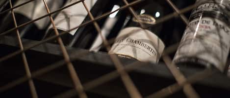 A wine rack with bottles, including a bottle labeled "Chambers."