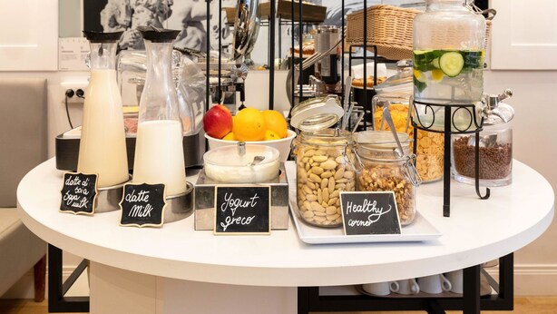 A buffet table with various food items and drinks, including dairy products, yogurt, and healthy options. - B&B Hotel Roma Italia Viminale (Rome)