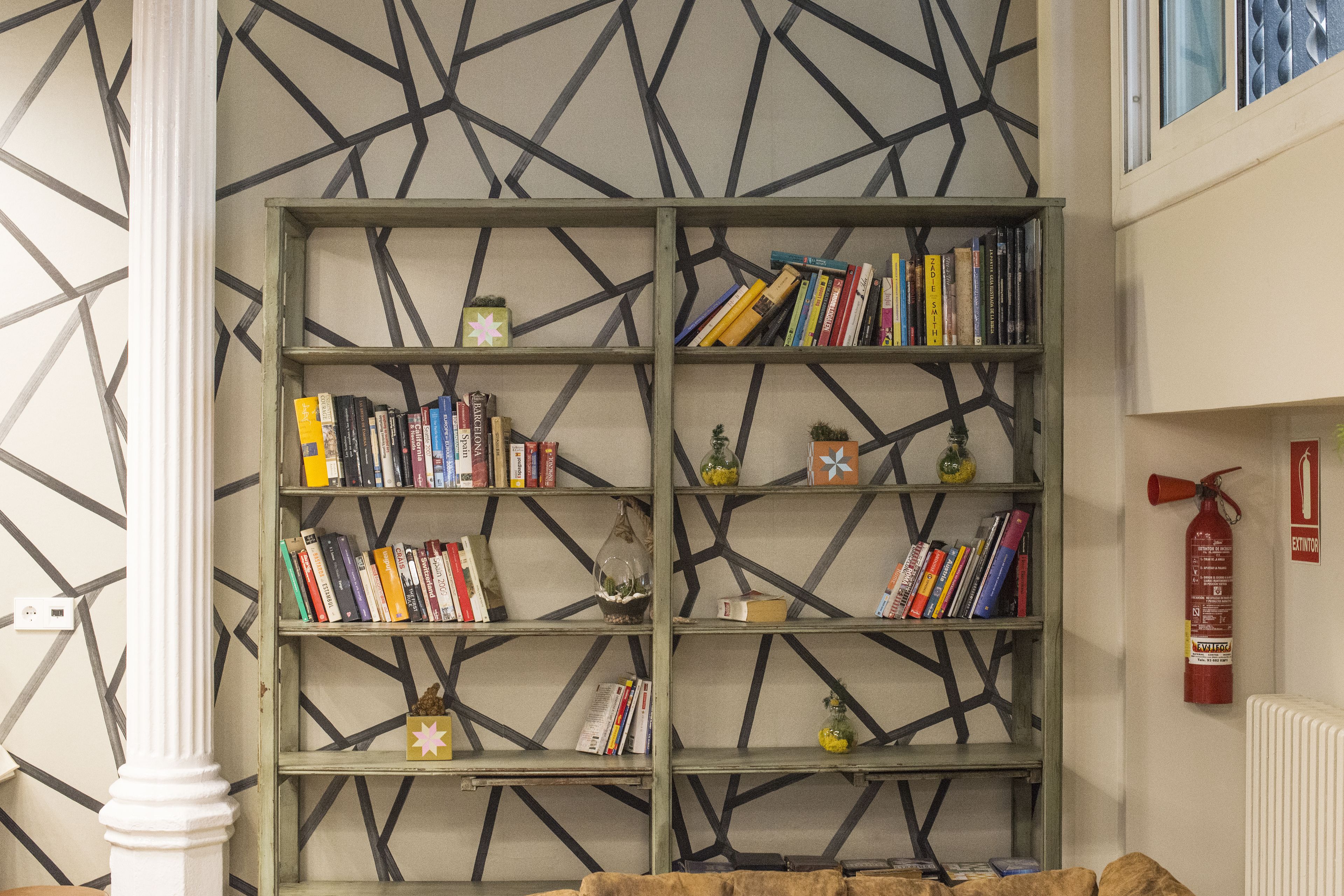 A bookshelf with various books and decorative items.