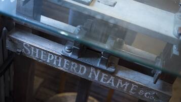 A metal structure with the inscription "SHEPHERD NEAME & CO."