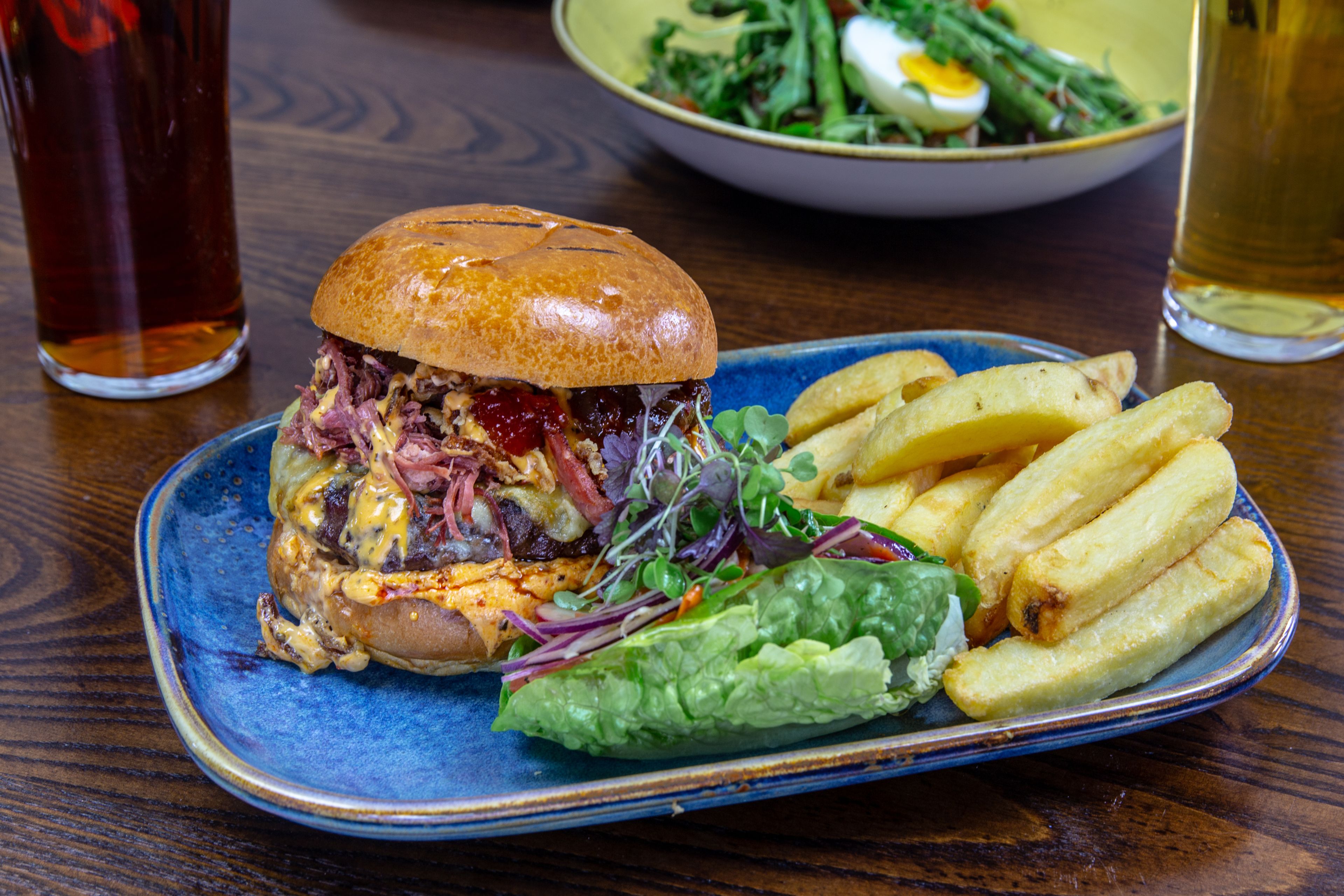 A plate with a sandwich, fries, and a salad.