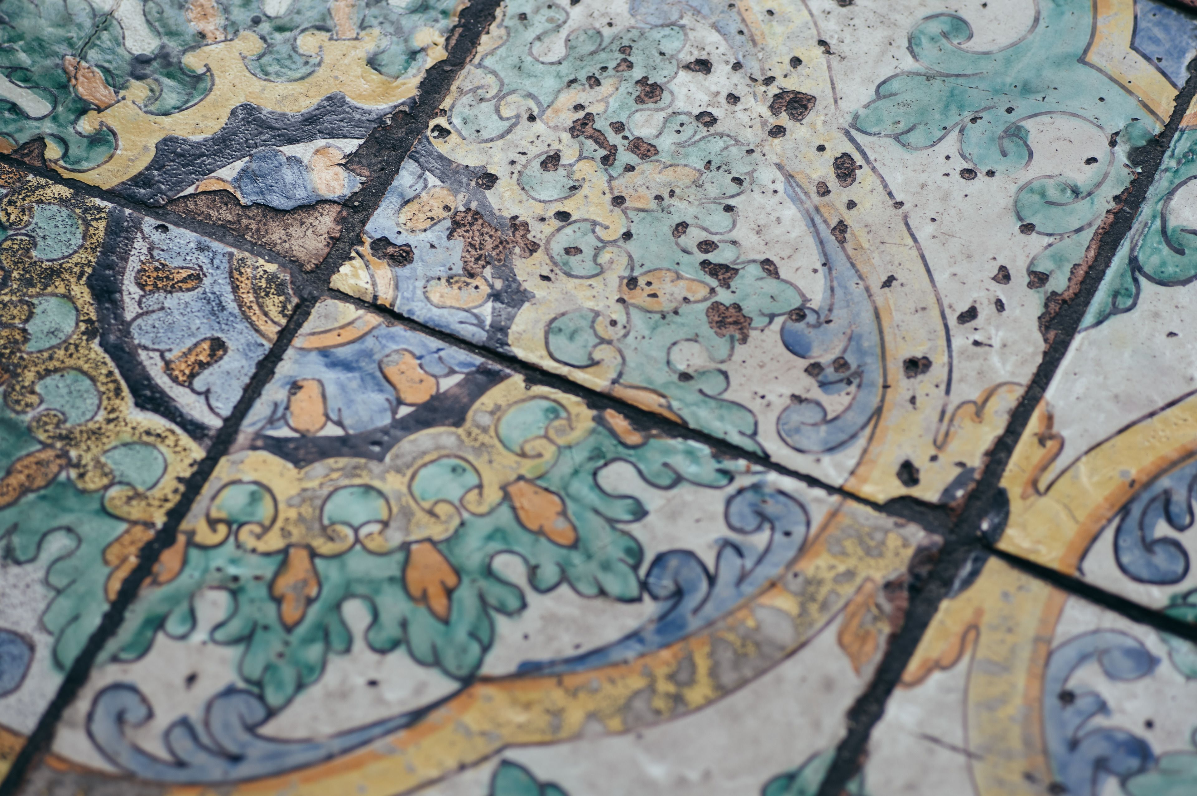 A close-up of a tiled floor with intricate patterns and designs.