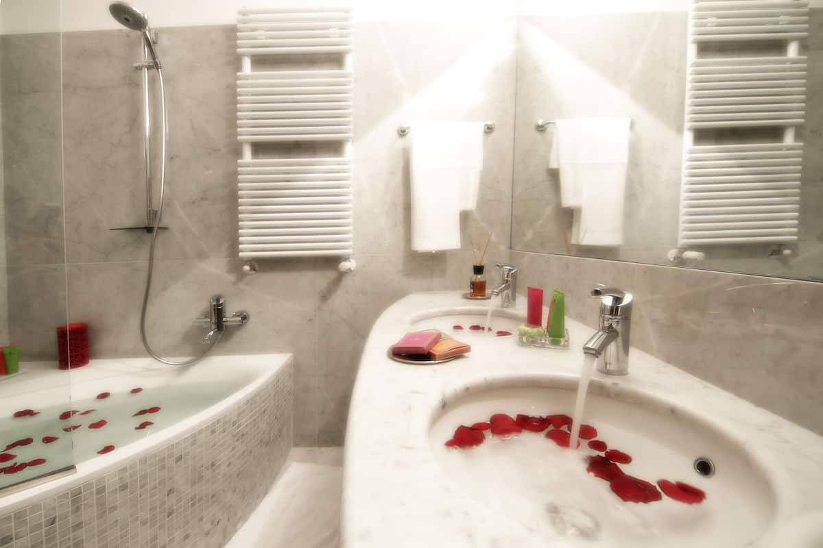 A bathroom with a bathtub, a sink, and a shower.