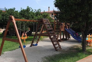 A playground with swings and a slide.