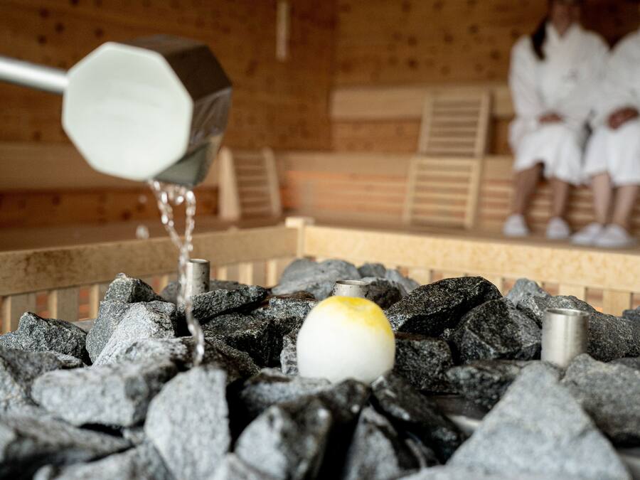 A hot spring bath with rocks and a yellow egg.