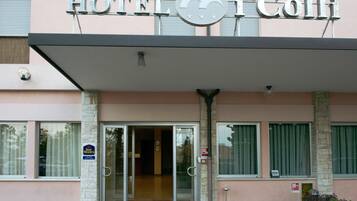 A hotel entrance with a sign reading "HOTEL i Colli".