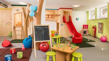 Children can play and learn in this interactive space with a slide, climbing frames, and building blocks.