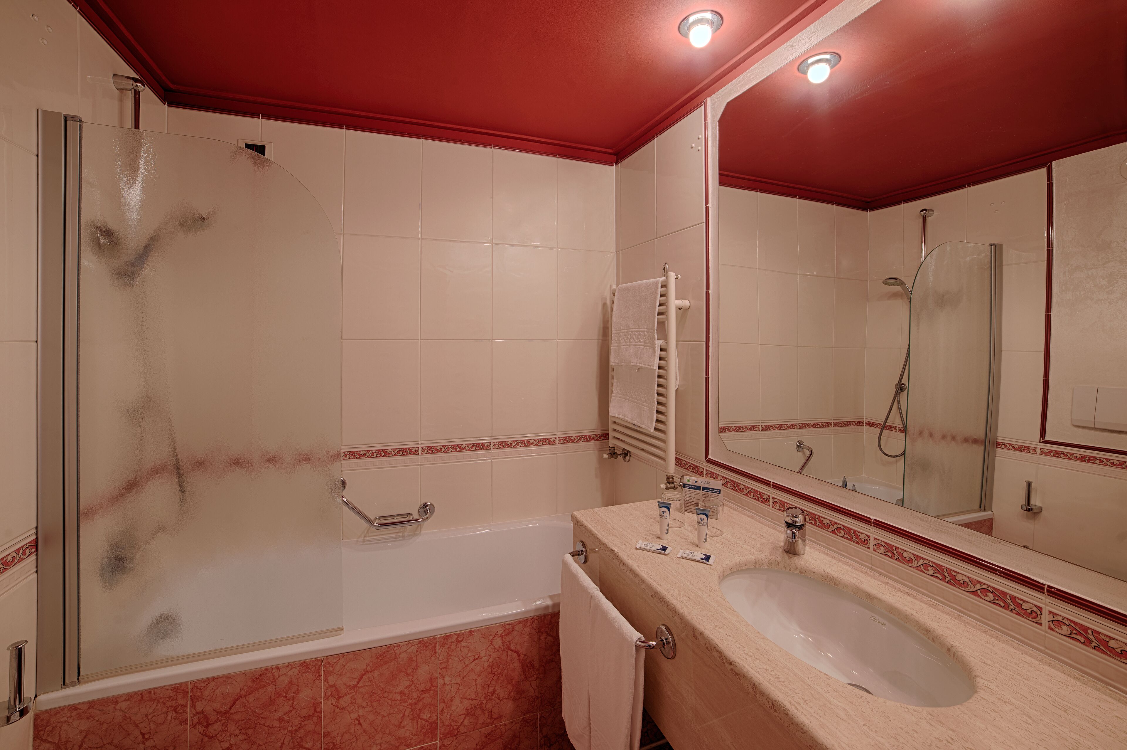 A bathroom with a bathtub, a sink, and a shower.