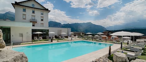 Seasonal outdoor pool, a waterfall pool, pool umbrellas, sun loungers