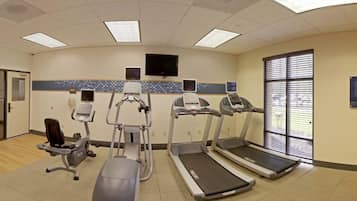 A fitness center with treadmills, elliptical machines, and a stationary bike.