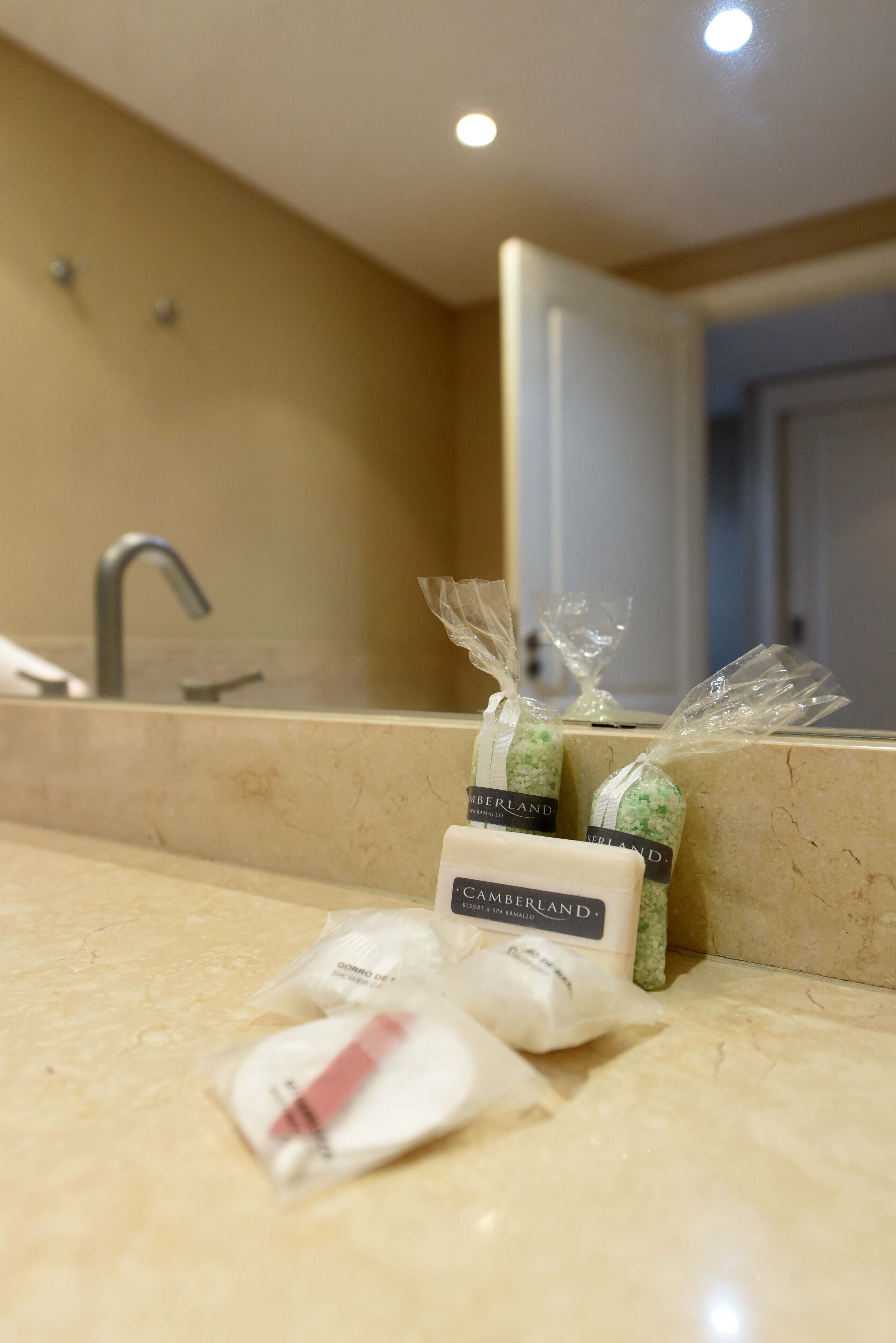 A bathroom counter with toiletries and a mirror.