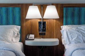 A hotel room with two beds, a bedside table with a lamp, a phone, and a small artwork on the wall. - Hampton Inn Elkhorn Lake Geneva Area (Elkhorn)