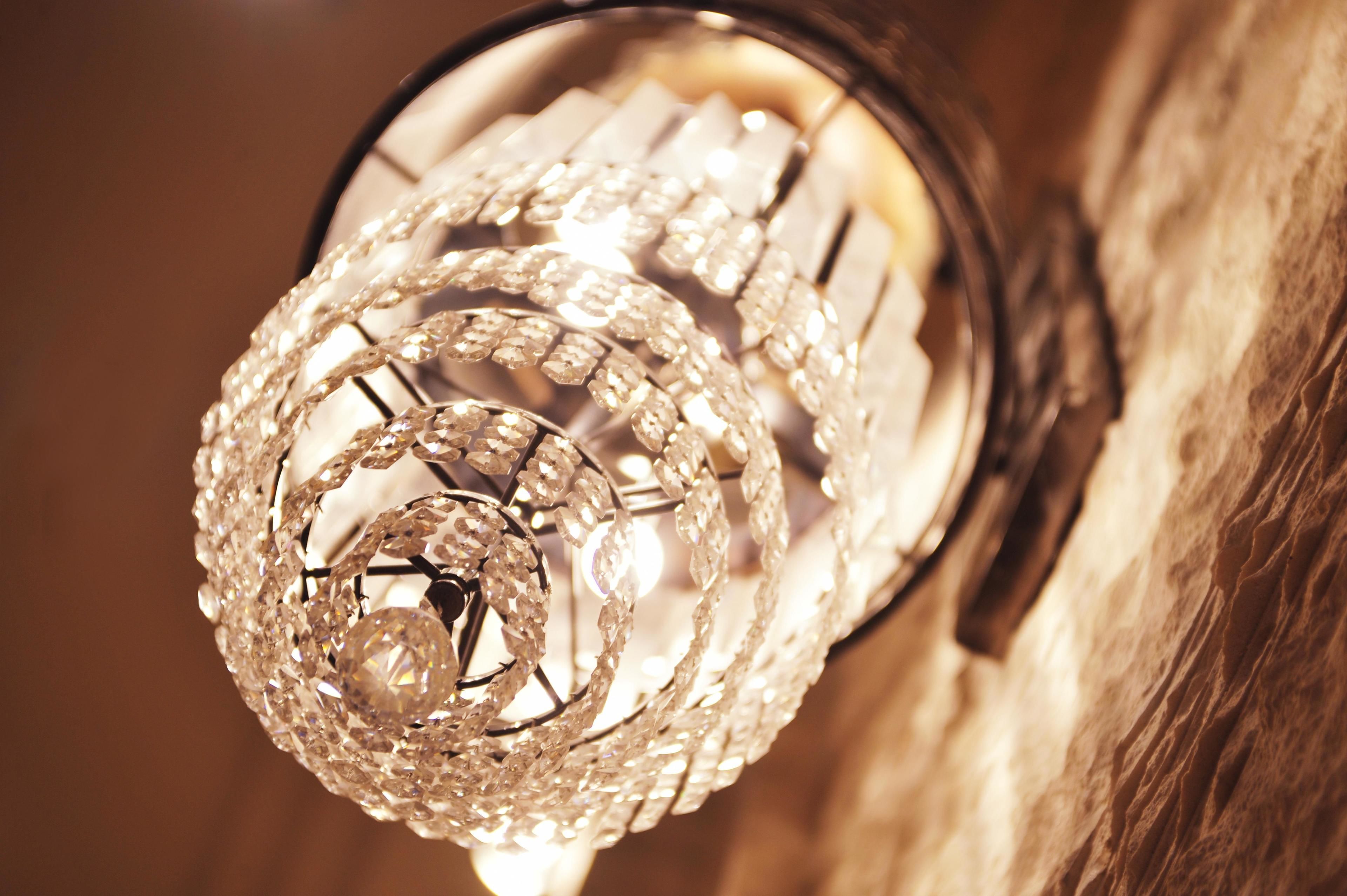 A chandelier with a spherical design and multiple crystal elements.