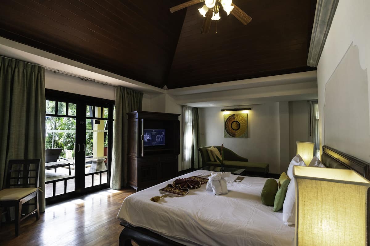 deluxe pool villa | living area | flat-screen tv, fireplace