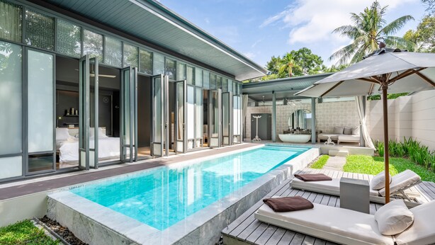 A modern house with a swimming pool, outdoor seating, and a covered patio. - SALA Phuket Mai Khao Beach Resort (Mai Khao)