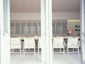A modern interior with white furniture, a patterned wall, and a lit lamp. - SALA Phuket Mai Khao Beach Resort (Mai Khao)