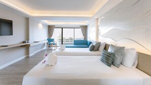 A modern hotel room with a large bed, a sofa, a TV, and a balcony with a view. - The Cha-am Methavalai Hotel (Cha-am)