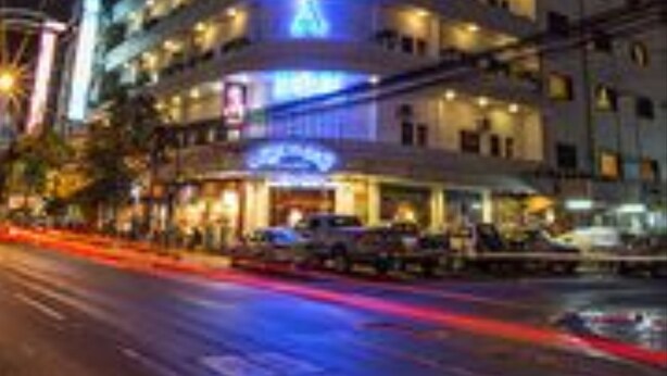 A multi-story hotel with illuminated signage, multiple floors, and a prominent entrance. - Asia Hotel (Phnom Penh)