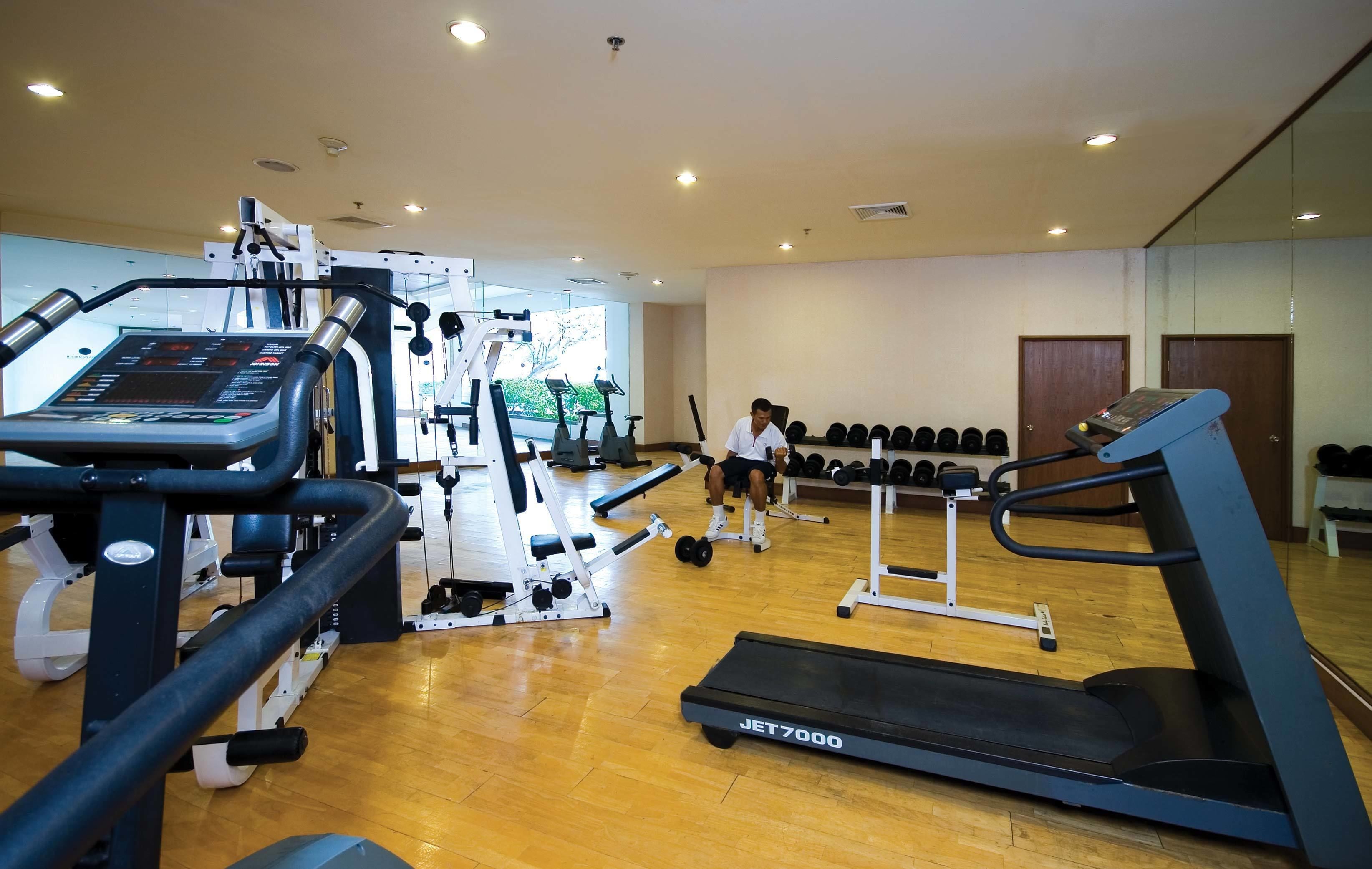 A gym with various exercise equipment, including treadmills and weight machines.