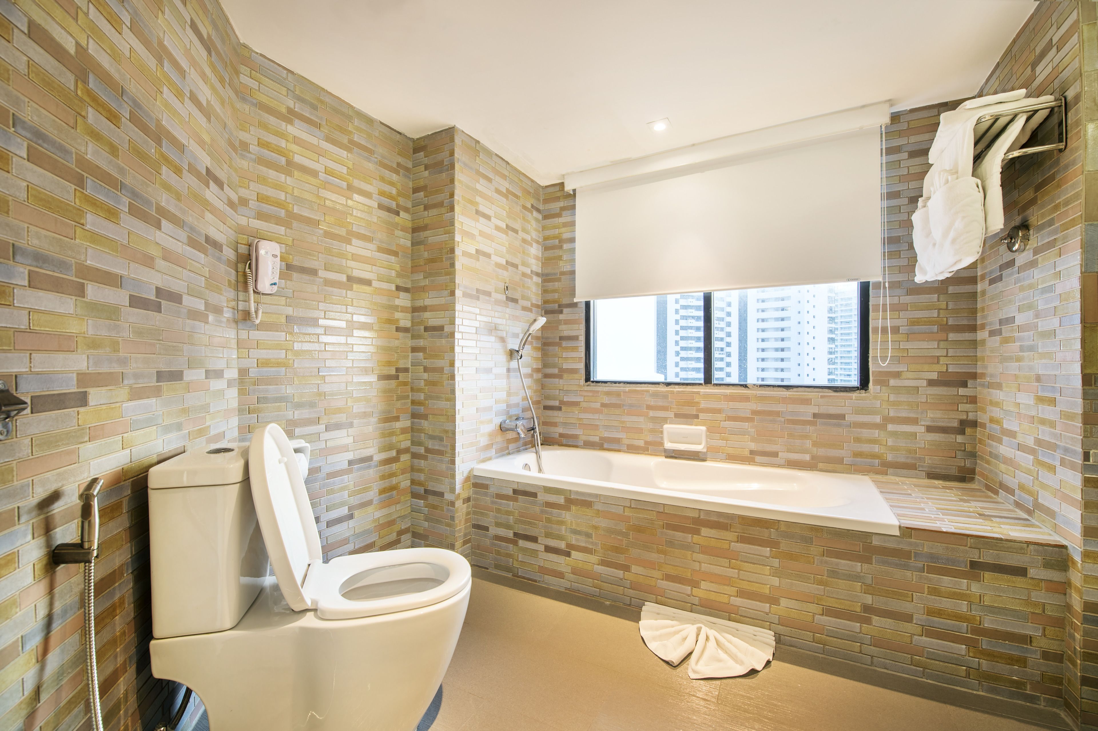 A bathroom with a toilet, a shower, and a bathtub.