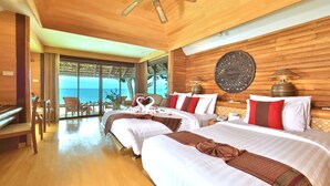 A hotel room with two beds, wooden flooring, a ceiling fan, and a large window overlooking the sea. - Sunset Park Resort and Spa by SWR (Sattahip)