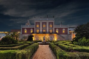 A grand building with a symmetrical facade, a central fountain, and a formal garden. - Pousada Palácio Estoi, Faro - Small Luxury Hotels Of The World (Faro)
