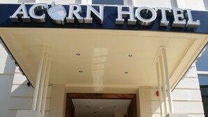 The exterior of the Acorn Hotel with a sign above the entrance and a set of stairs leading up to the door. - Acorn Hotel (Glasgow)