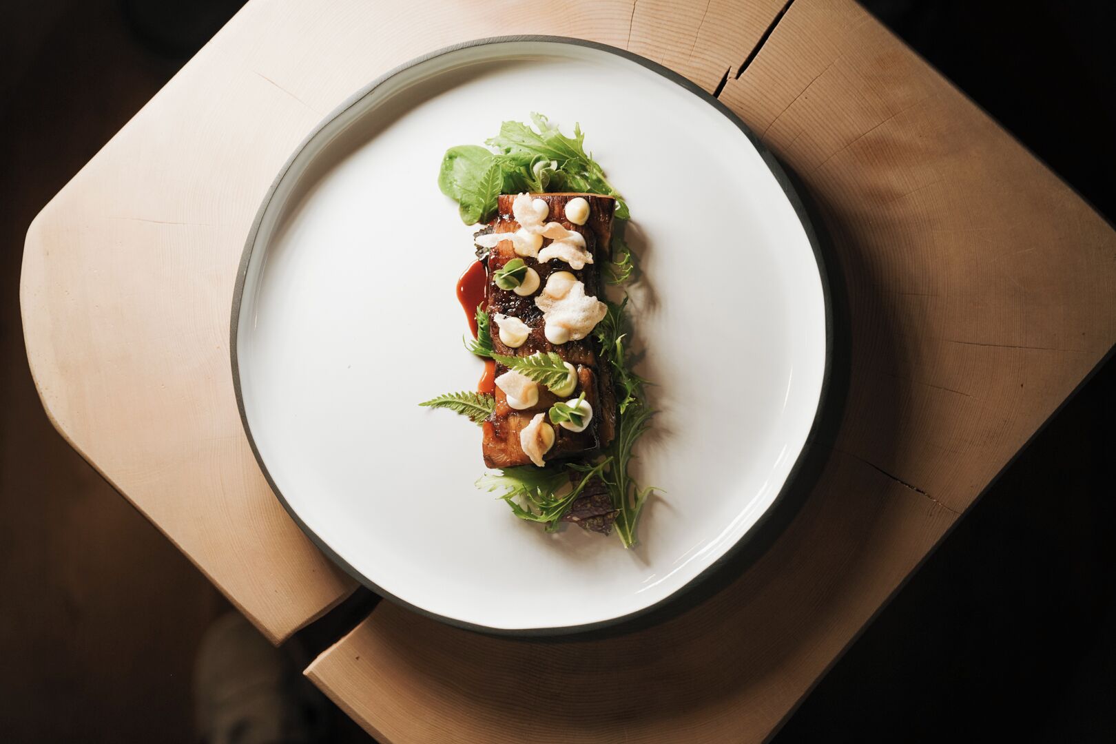 A plate of food on a wooden table.