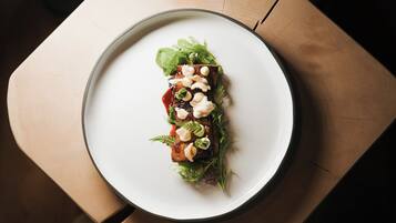 A plate of food on a wooden table.