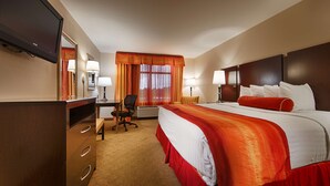 A hotel room with a bed, desk, chair, and a television. - Best Western Plus Jacksonville West (Jacksonville)