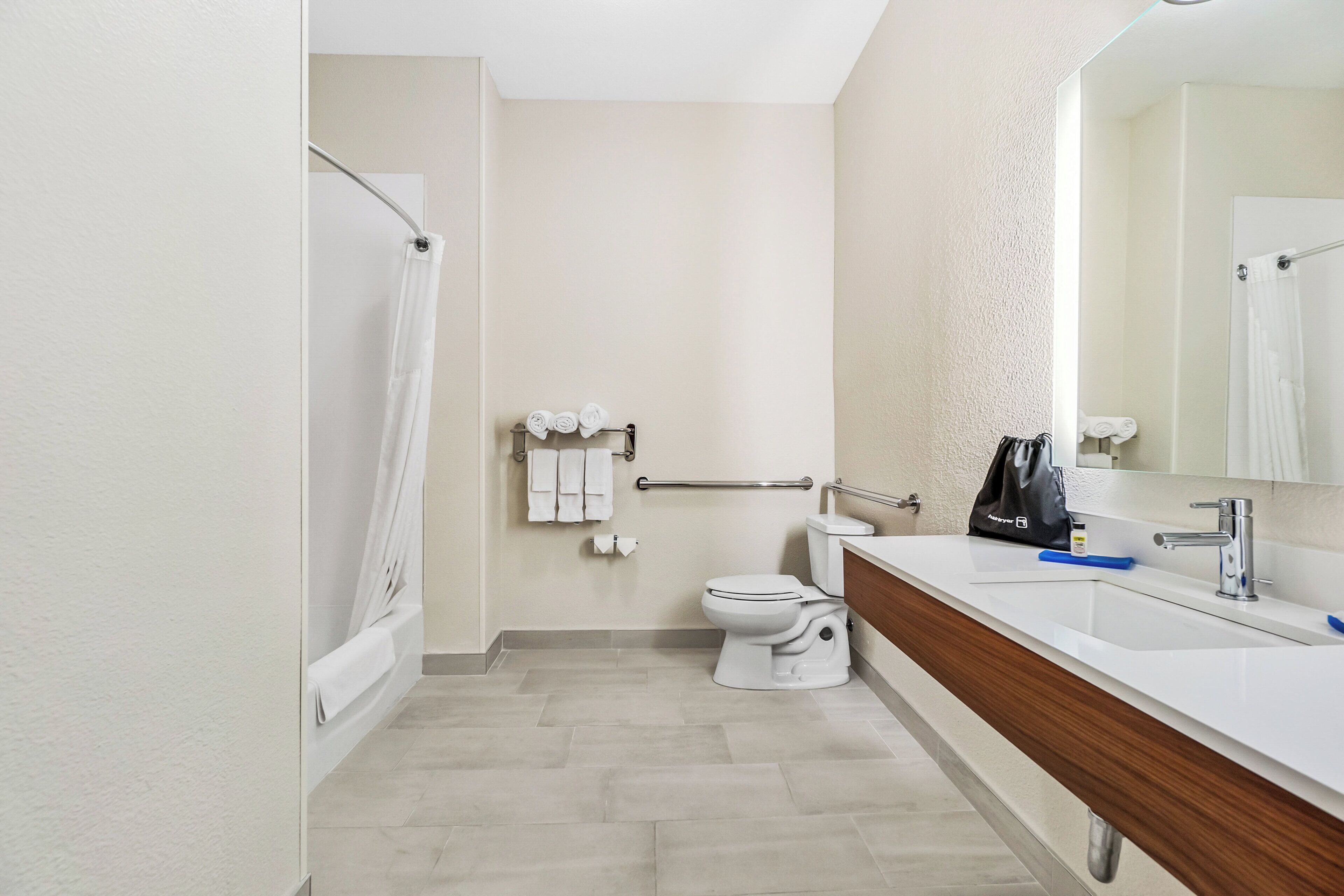 A bathroom with a bathtub, toilet, and sink.