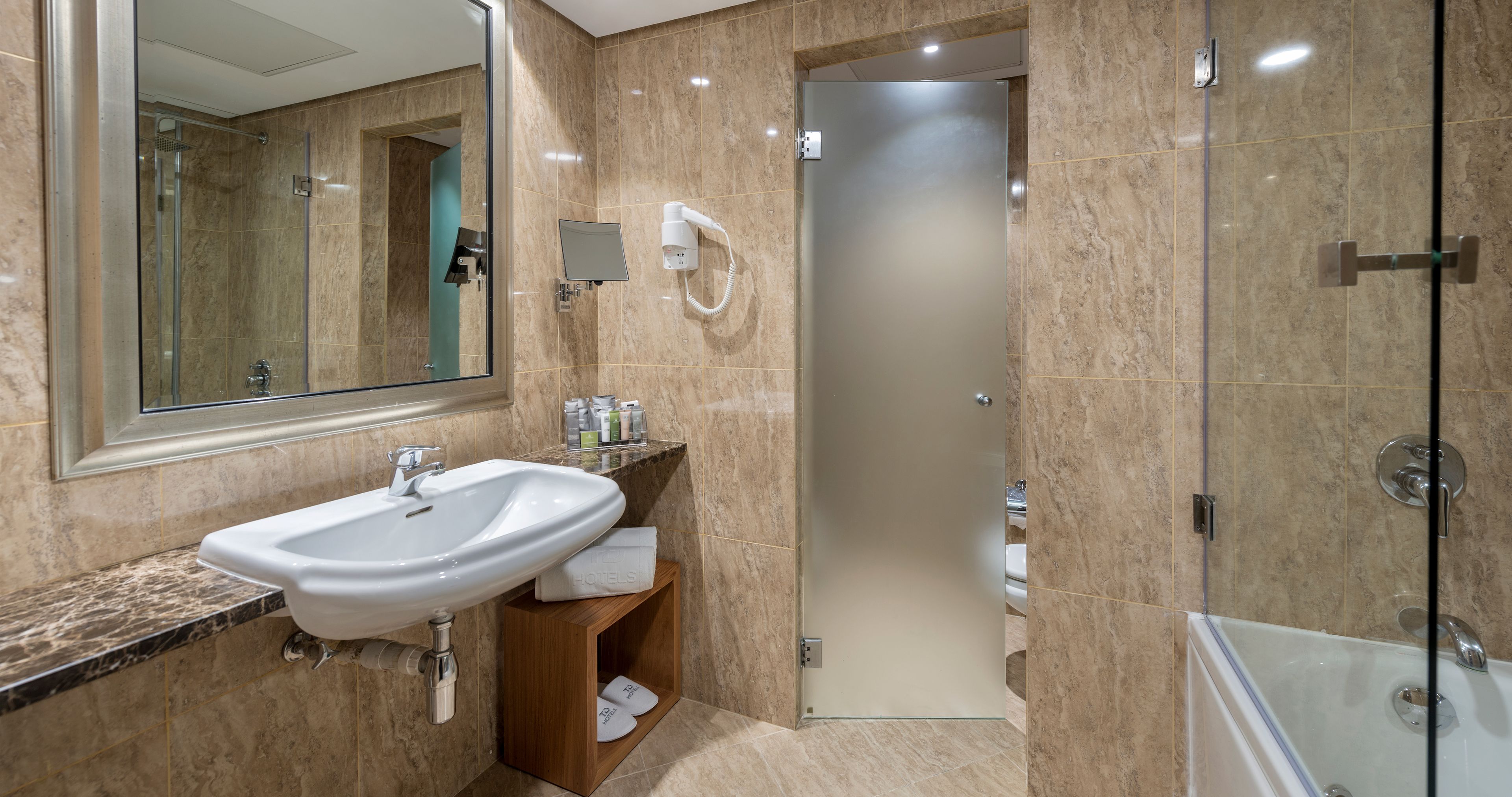junior suite | bathroom | combined shower/bathtub, designer toiletries, hair dryer, bathrobes