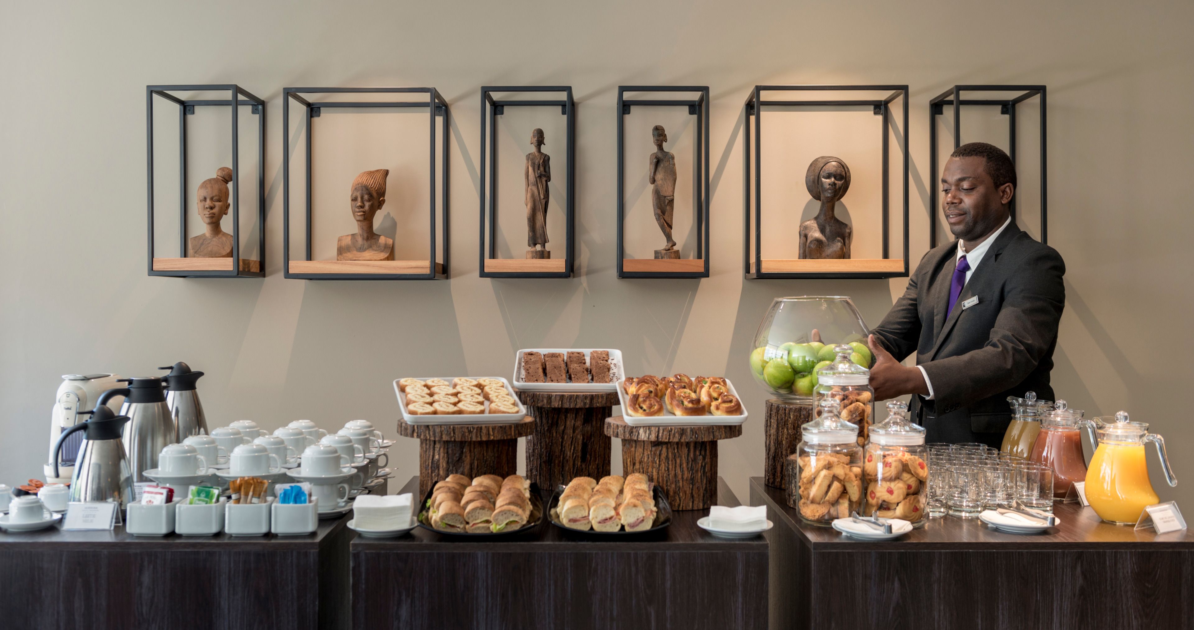 A breakfast buffet with various food items and a coffee station.