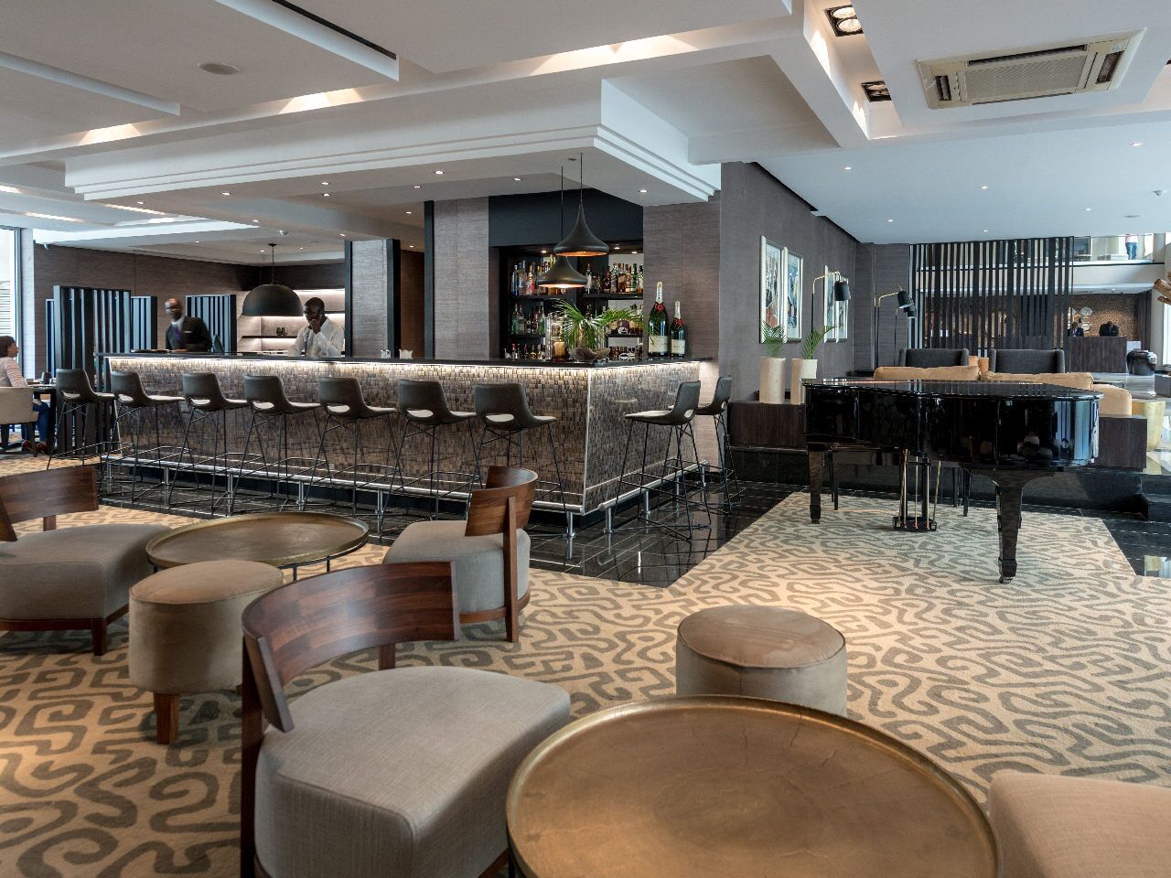 A modern bar area with seating and a bar counter.