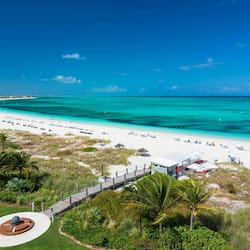 On the beach, white sand, sun loungers, beach umbrellas