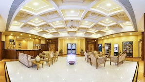 A spacious lobby with a high ceiling, a reception desk, and multiple seating areas. - Club Mahindra Kumbhalgarh (Rajsamand)