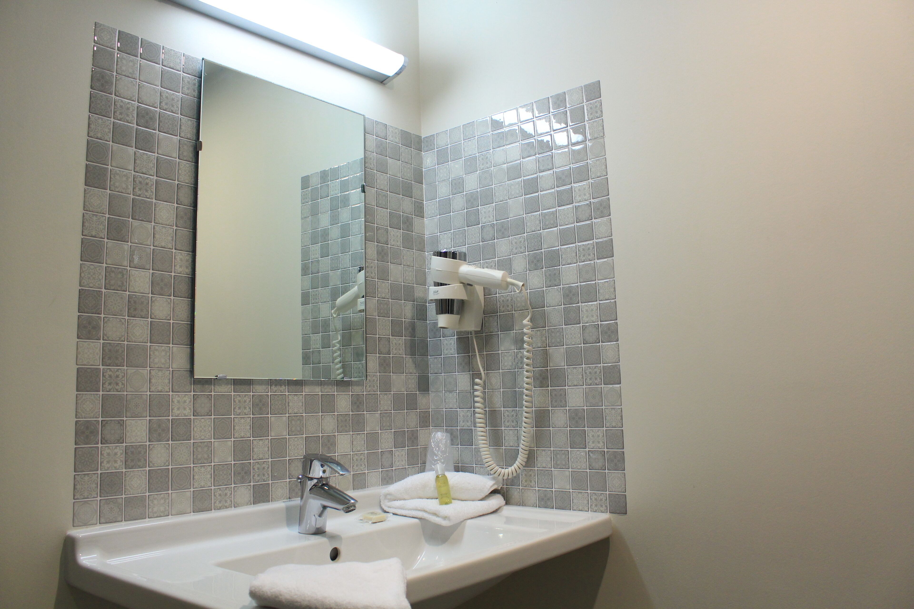 shower, designer toiletries, hair dryer, towels