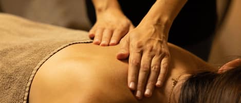 A close-up of a massage being performed on a person's back.