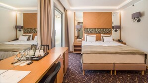 A hotel room with two beds, a desk with coffee-making equipment, a mirror, and a patterned carpet. - Marmara Hotel Budapest (Budapest)