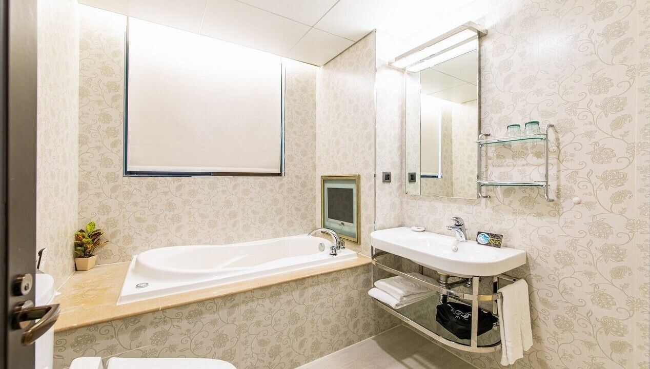 economy double room | bathroom | separate bathtub and shower, hair dryer, slippers, electronic bidet