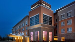 A hotel with a prominent "DoubleTree" sign, multiple windows, and a covered entrance area.