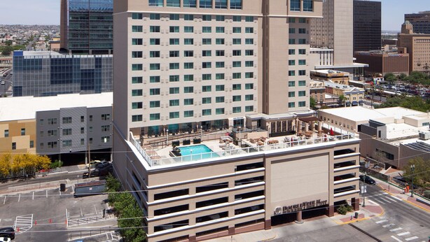 A hotel with a rooftop pool, multiple floors, and a modern architectural design. - DoubleTree by Hilton El Paso Downtown (El Paso)
