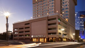 A DoubleTree by Hilton hotel with a multi-story parking garage and a modern building adjacent to it. - DoubleTree by Hilton El Paso Downtown (El Paso)